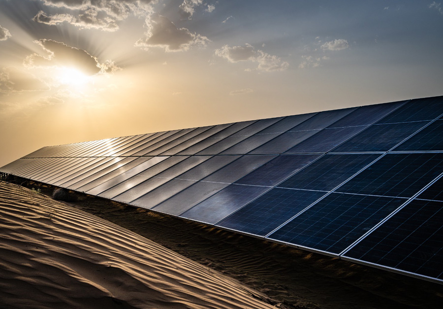 Solar farm at sunset with photovoltaic panels generating renewable energy